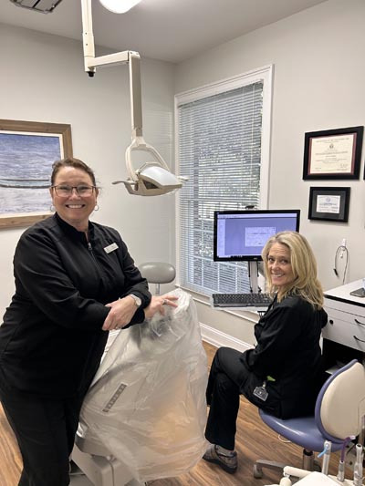 Two Wrightsville Dental team members in a treatment room with digital imaging equipment